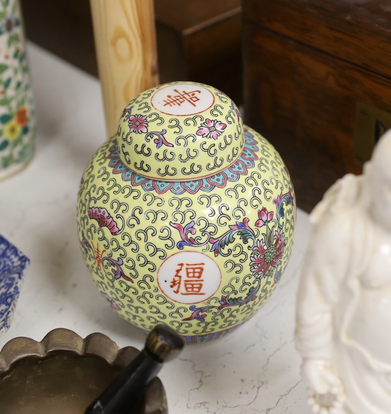 A collection of mostly Chinese ceramics, to include a vase, a lion dog, pestle and mortar etc.